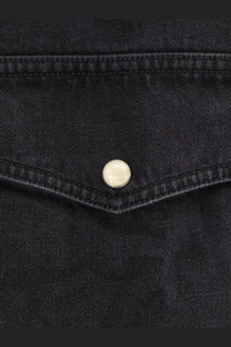 Studio nicholson men’s black denim shirt black featuring a silver button on a black denim jacket front