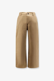 Beige wide-leg Studio Nicholson men’s chino cotton trousers with a clean tailored fit and single button closure at the waist