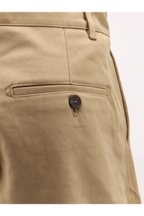 Khaki cotton chino trousers by Studio Nicholson with a dark brown button on the front pocket for men