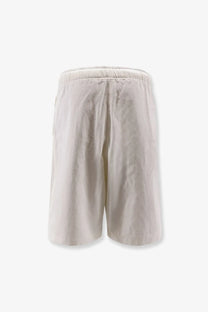 Studio Nicholson men’s cotton bermuda shorts in cream with elastic waistband and relaxed casual design