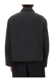 Studio Nicholson men’s Harrington jacket in black with minimalist design and structured collar