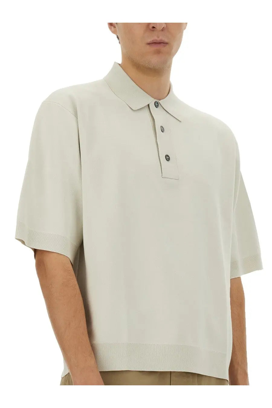 Studio Nicholson men’s knitted polo shirt in light beige with ribbed collar cuffs and dark buttons down the placket