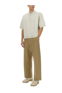 Studio Nicholson men’s knitted polo in light beige with short sleeves classic collar and three-button placket