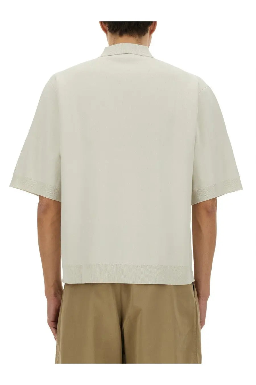 Studio Nicholson men’s knitted polo white in off-white with short sleeves and a clean tailored fit
