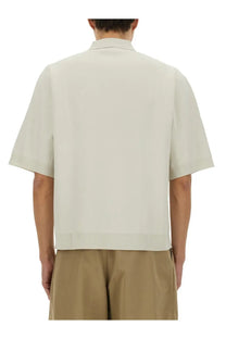 Studio Nicholson men’s knitted polo white in off-white with short sleeves and a clean tailored fit