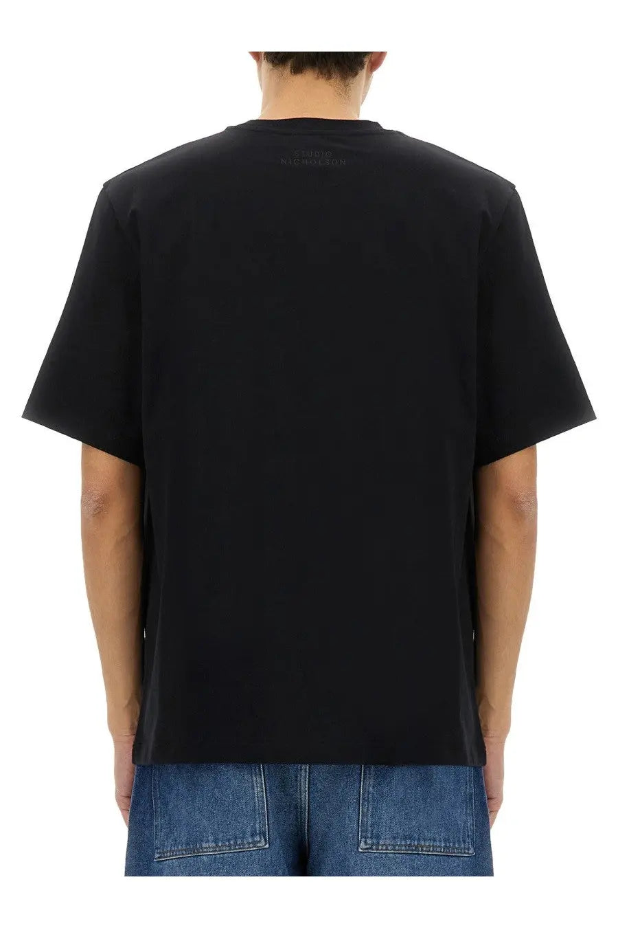Studio nicholson men’s black short-sleeved t-shirt with subtle brand logo at the neckline in a soft fabric
