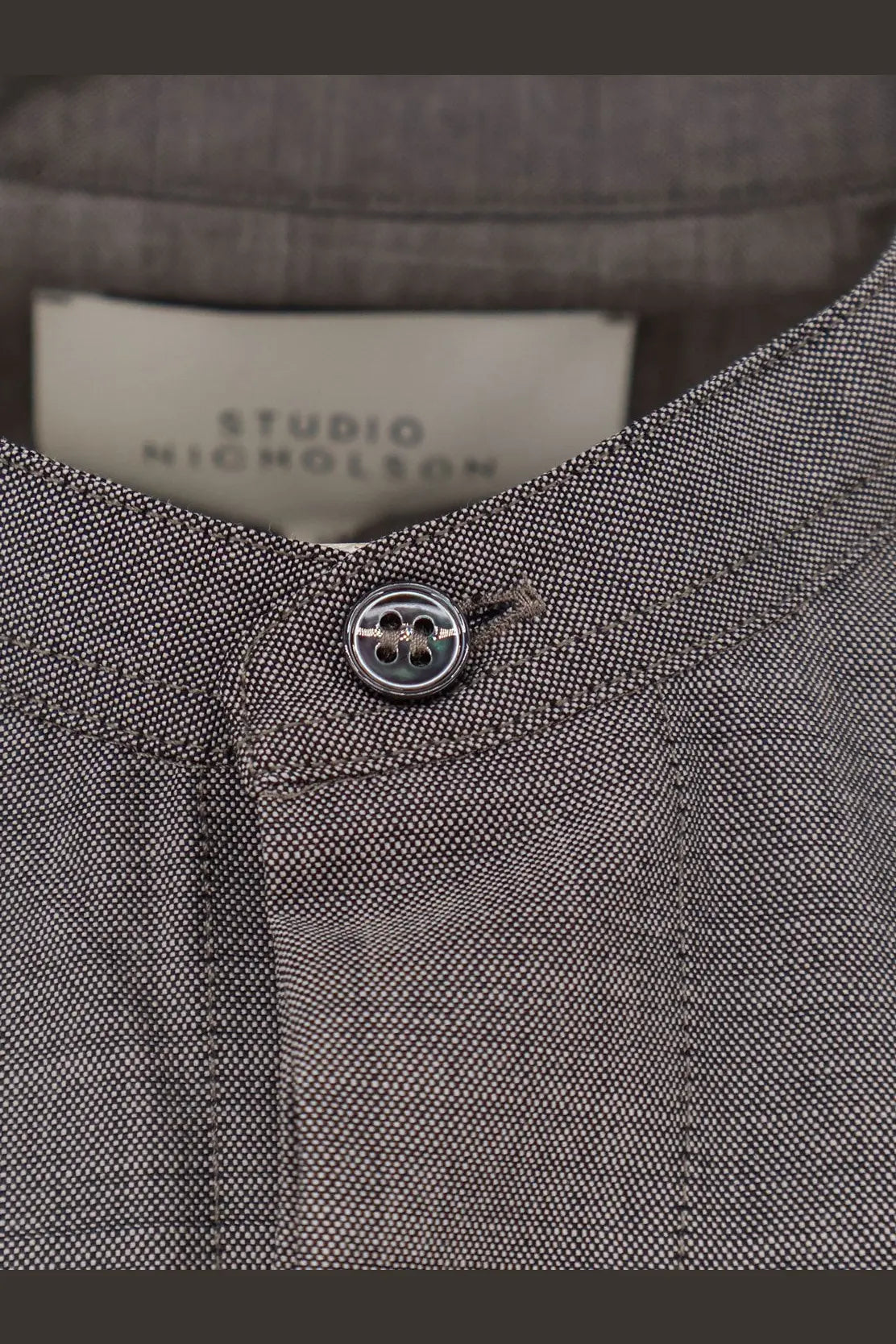 Studio Nicholson men’s grey wool shirt with textured fabric and silver four-hole button studio nicholson label