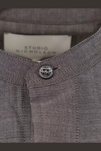 Studio Nicholson men’s grey wool shirt with textured fabric and silver four-hole button studio nicholson label
