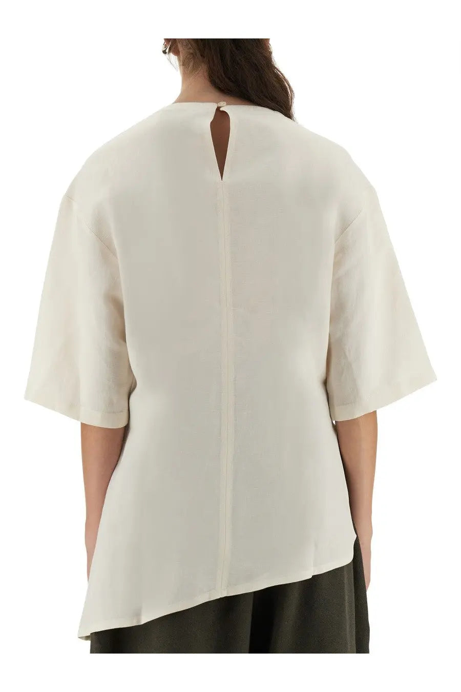 Studio nicholson women’s cream-colored loose-fitting blouse with short sleeves and central back slit shown from back side