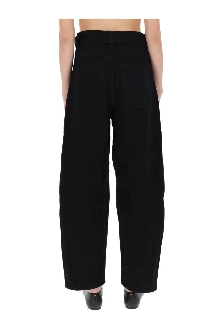 Back view of Studio Nicholson women’s black high-waisted wide-leg trousers with straight cut and two rear patch pockets