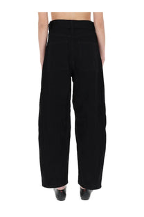 Back view of Studio Nicholson women’s black high-waisted wide-leg trousers with straight cut and two rear patch pockets