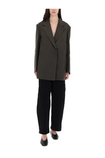 Olive green oversized blazer with structured relaxed fit and minimalist design paired with studio nicholson black pants