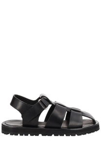 Studio nicholson women’s black leather sandal with chunky sole and adjustable strap shown from the back side