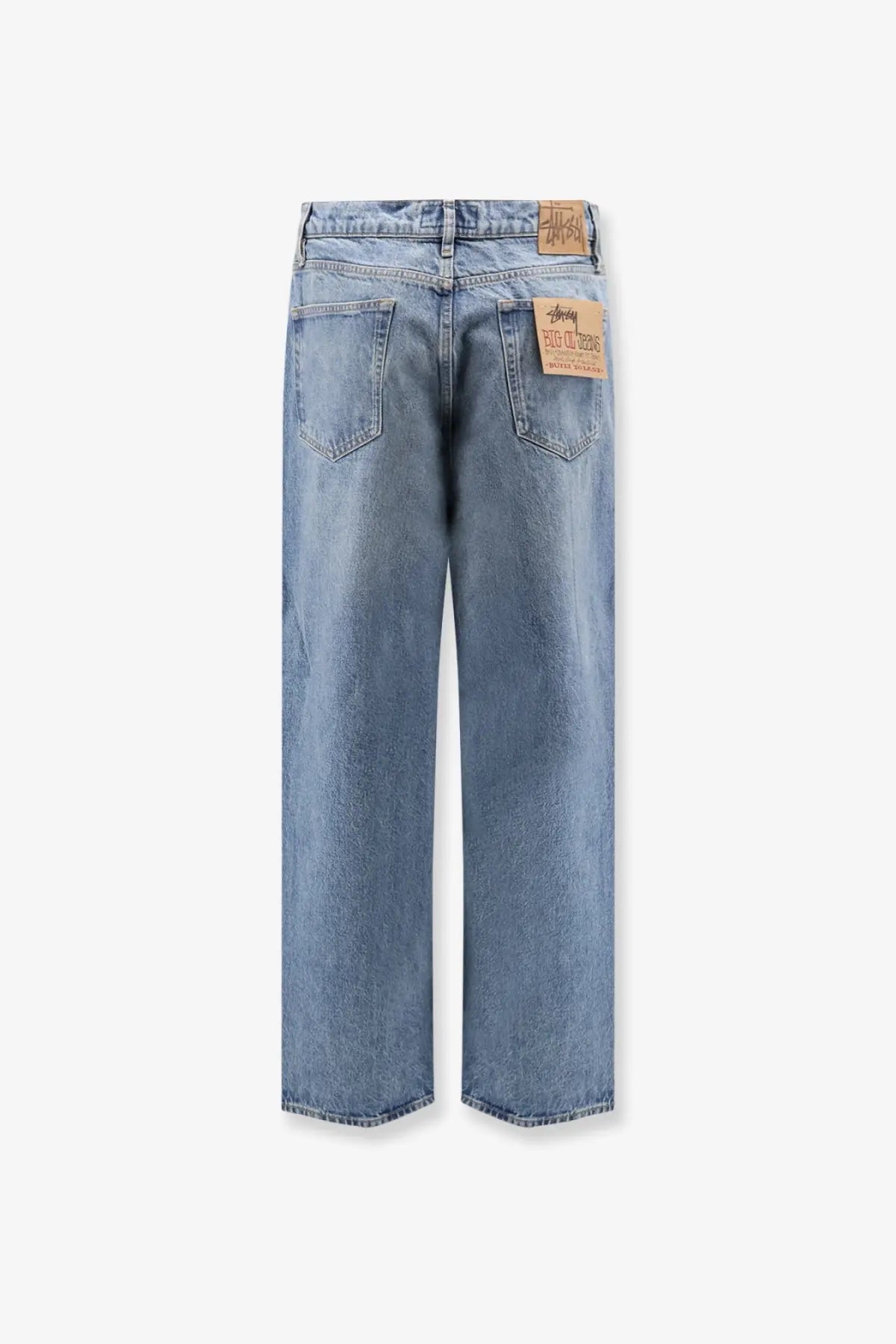 Stussy men’s big ol jean blue light-wash denim jeans back side with relaxed wide-leg cut and brown leather brand tags