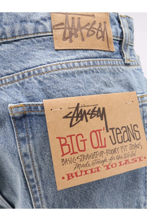 Stussy men’s big ol jean blue light-wash denim with classic straight fit and brown leather brand patch back side view