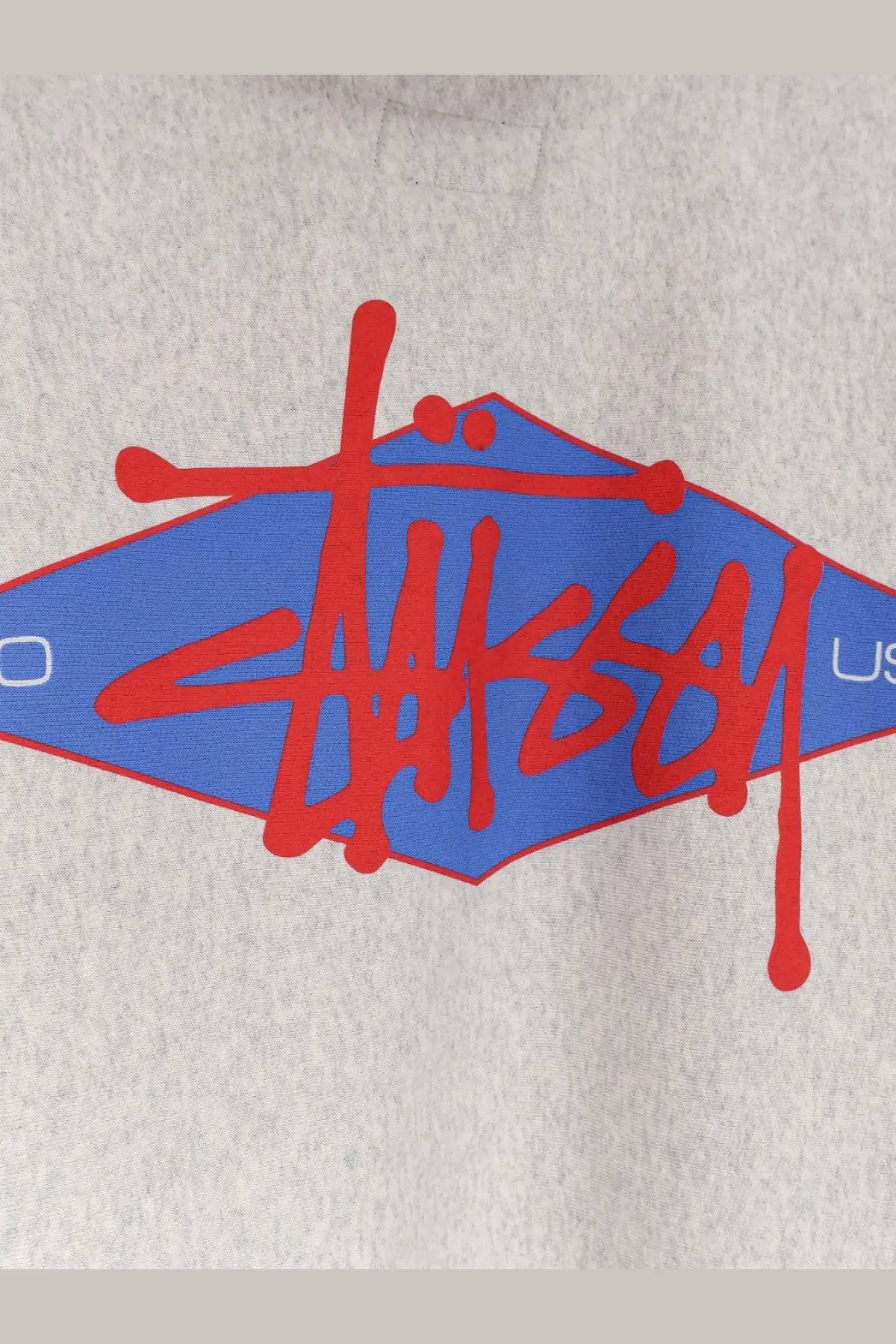 Stussy men’s grey cotton blend sweatshirt with bold red and blue diamond logo and signature graffiti lettering
