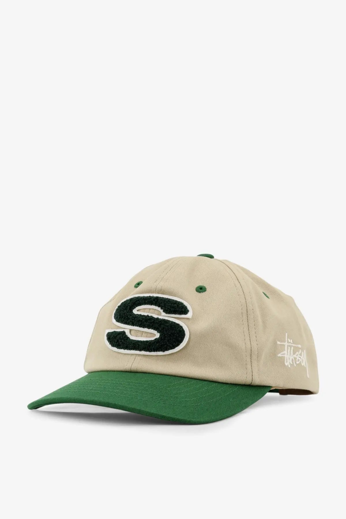 Beige and green two-tone stussy men’s cotton baseball cap with bold black embroidered s and matching green brim and button