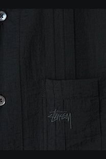 Black Stussy men’s button-up shirt made of lyocell and nylon blend with subtle embroidered logo on chest pocket