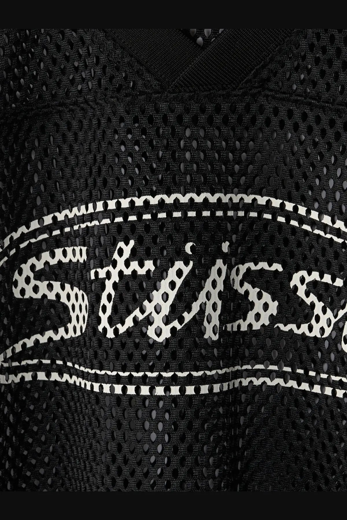 Black mesh Stussy men’s perforated nylon athletic jersey with white stitched logo and dotted outline