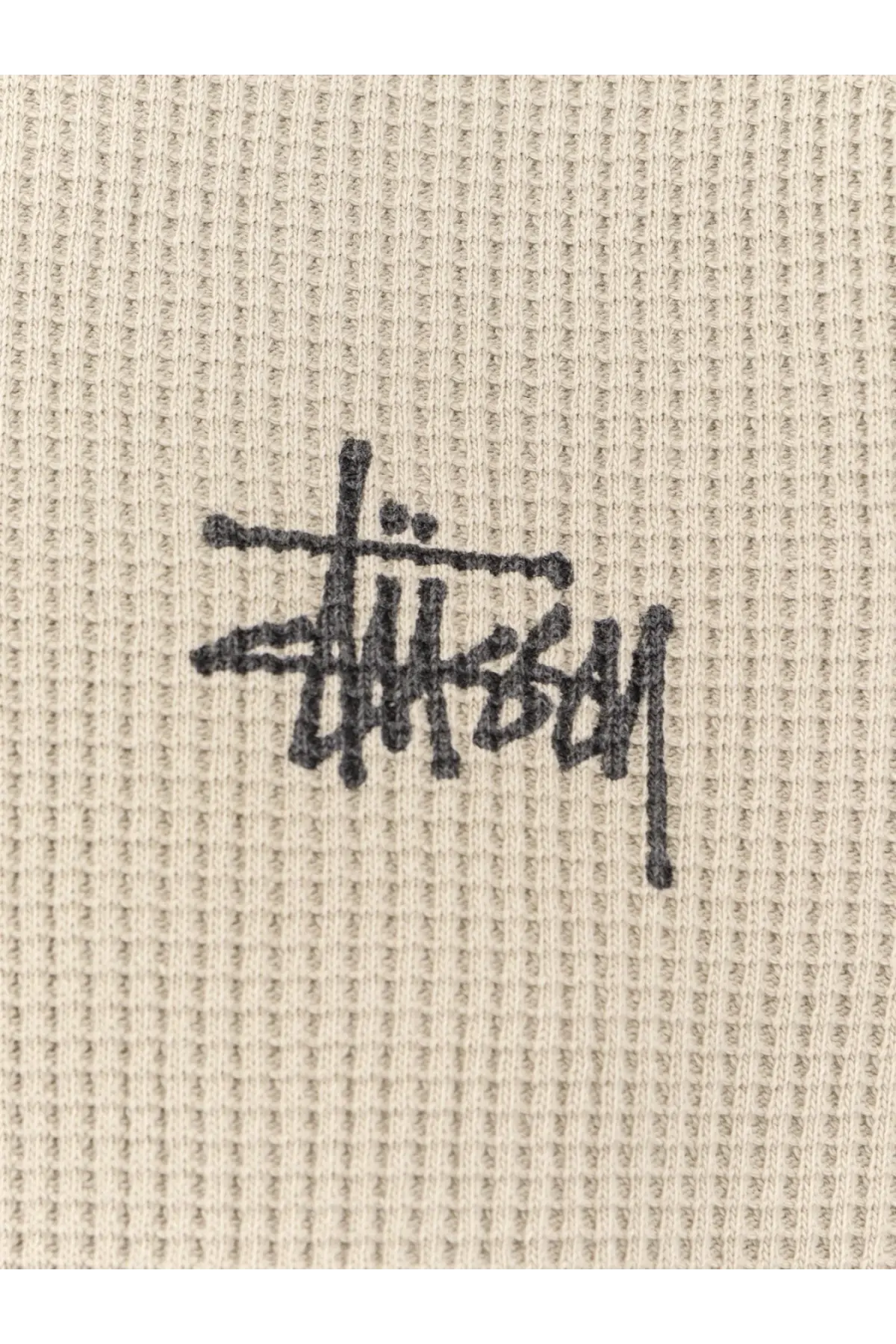 Beige waffle knit stussy men’s thermal cotton sweater with black logo embroidered on the chest bone color