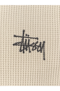 Beige waffle knit stussy men’s thermal cotton sweater with black logo embroidered on the chest bone color
