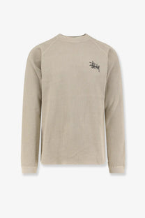 Beige waffle knit cotton long sleeve crewneck sweater with black embroidered Stussy logo on left chest bone color