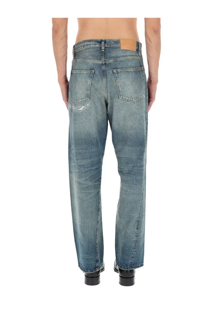 Back view of sunflower men’s jeans wide twist blue medium-wash denim with faded distressed look and frayed back pockets