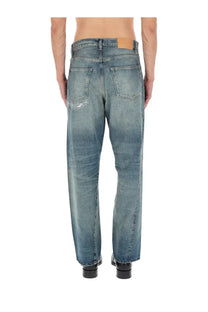 Back view of sunflower men’s jeans wide twist blue medium-wash denim with faded distressed look and frayed back pockets