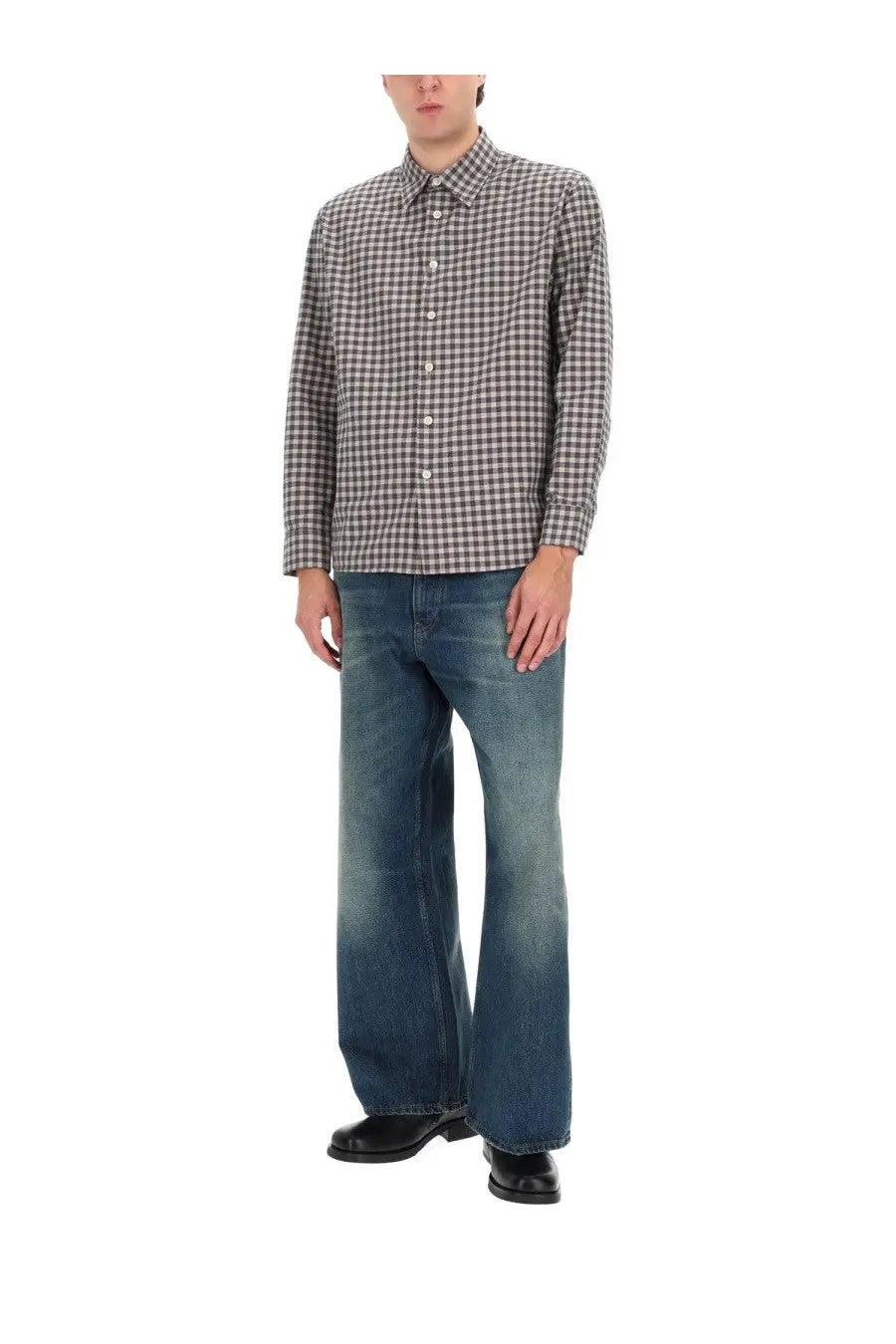 A man wearing a black and white checkered long sleeve shirt modeled with sunflower men’s super wide blue jeans front view
