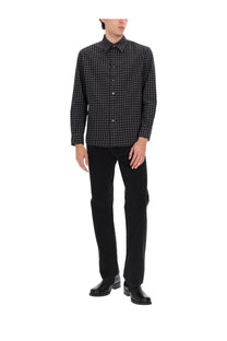 Black and gray checkered long-sleeve button-down shirt paired with sunflower men’s wide twist jeans black