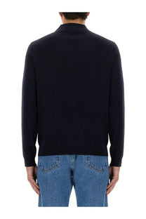 A navy blue men’s wool polo sweater with long sleeves and ribbed collar and cuffs by Sunflower