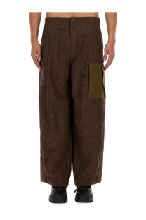 Brown wide-leg cargo pants with contrasting olive green patch pocket by ten c and awake ny in ten green color