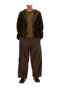 Olive green hooded jacket with button closures and patch pockets paired with ten c men cargo pants awake ny ten green