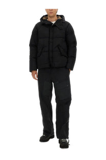Ten c men’s down jacket artic black is a black puffer jacket with a beige fur-lined hood and two front pockets