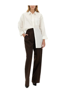 Thelatest women’s brown axel pants paired with a white oversized button-down shirt with rolled cuffs and chest pocket