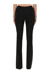 The back side of black tailored straight-leg trousers with subtle pleats from the latest women’s an pants collection