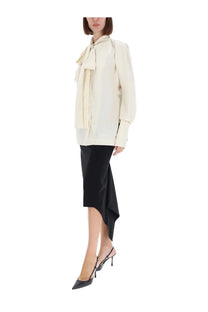 Thelatest women’s shirt Cecilia yellow cream-colored satin blouse with a prominent bow at the neckline