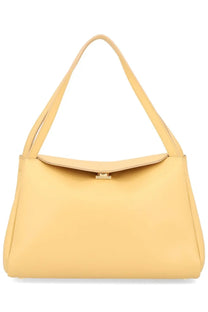 A sleek pale yellow leather shoulder bag with minimalist design and small metallic clasp themoire women’s bag eudora beige