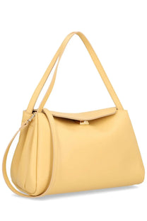 A sleek pale yellow leather shoulder bag with minimalist design and gold tone hardware from Themoirè Eudora beige collection