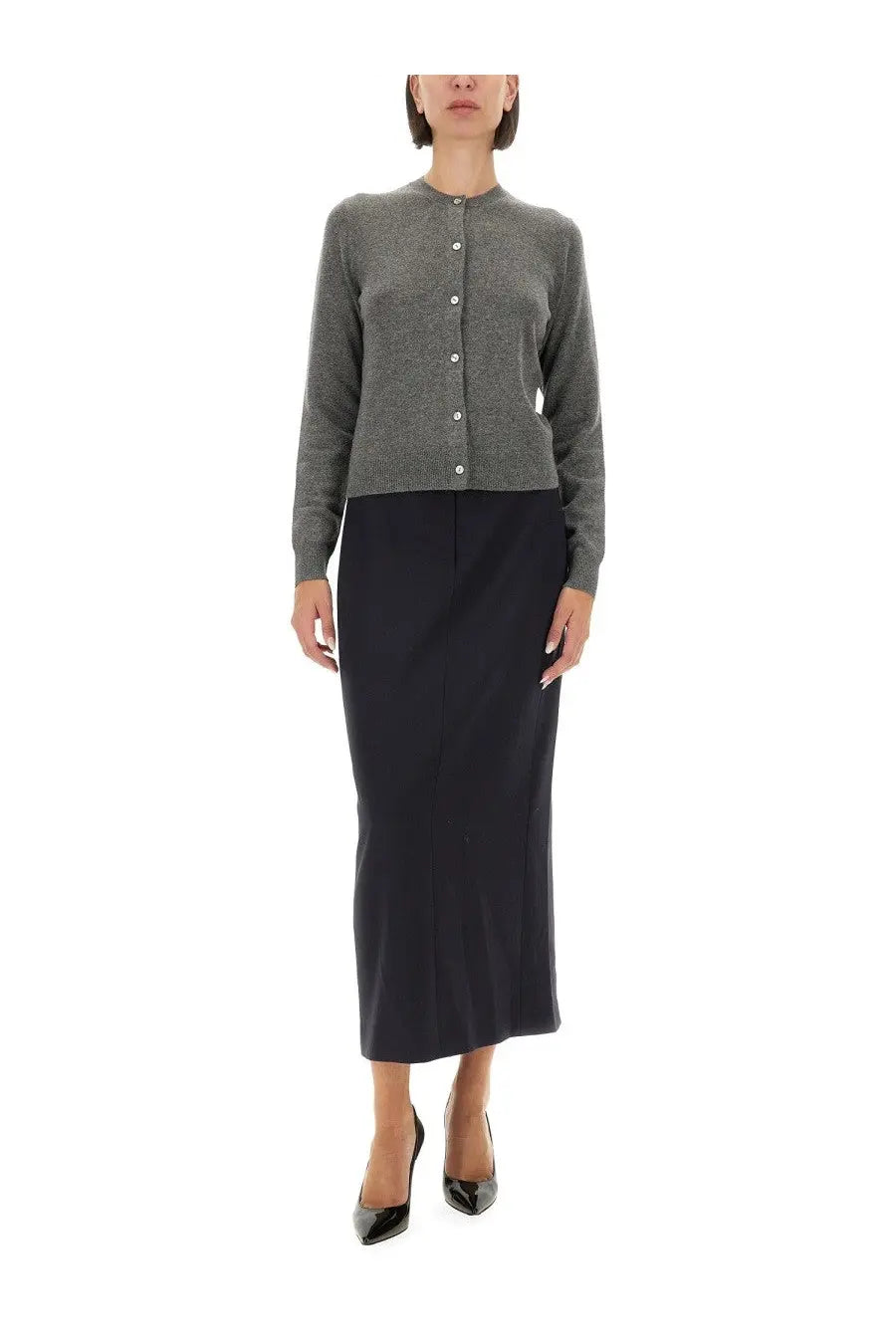 A gray textured knit cardigan with a subtle pattern and white buttons paired with theory women’s midi skirt blue