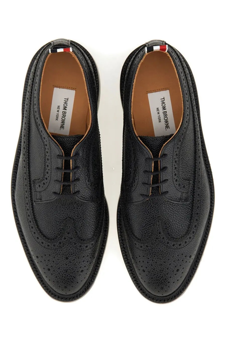 Thom Browne men’s black leather brogue oxford shoes with perforated detailing and red white blue heel tab back view