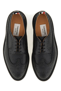Thom Browne men’s black leather brogue oxford shoes with perforated detailing and red white blue heel tab back view