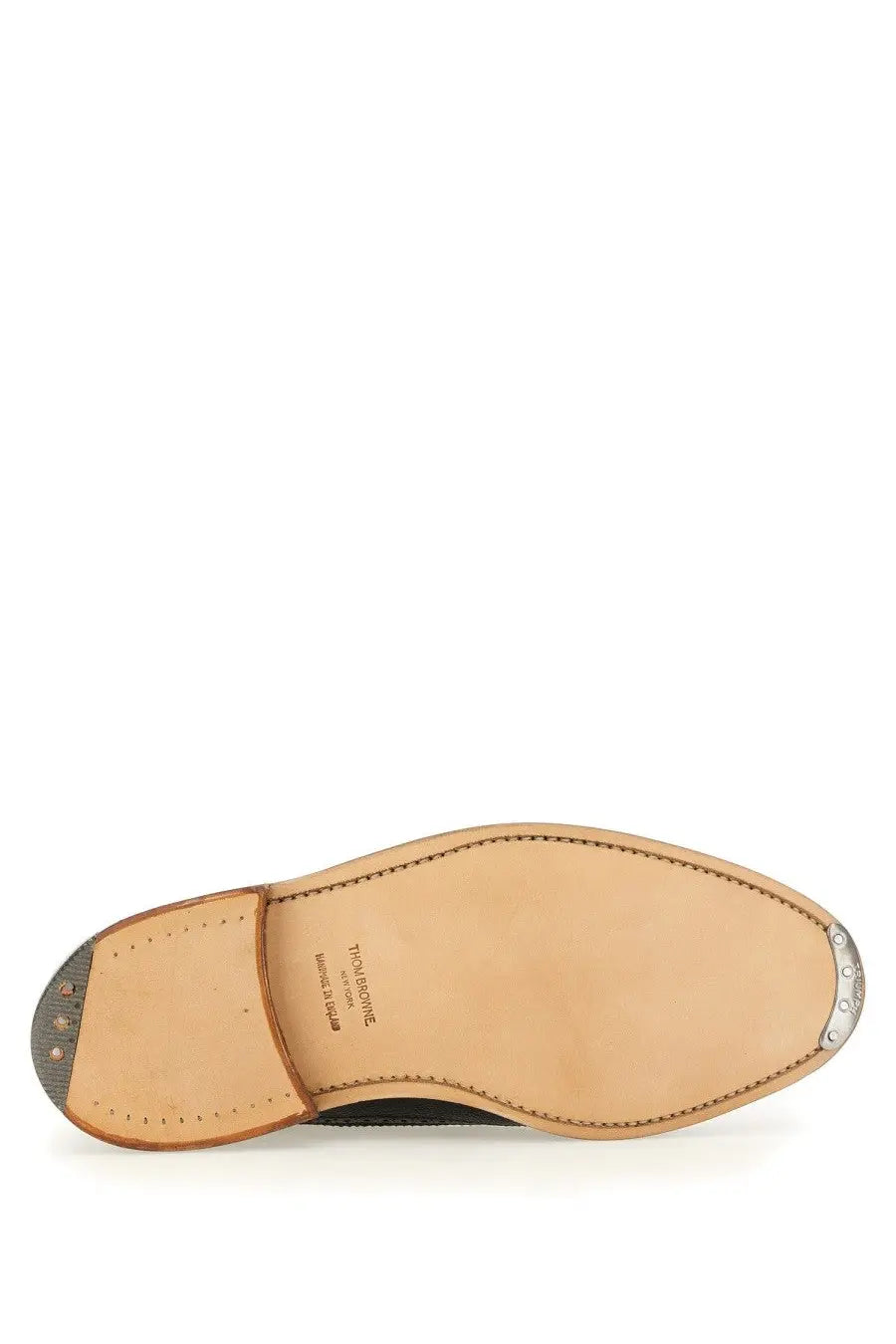Tan leather sole of thom browne men’s brogue classic longwing black shoe with stitched edges and metal heel cap