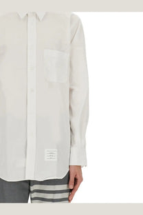 Thom Browne men’s white button down shirt with subtle texture and a small branded label at the hem