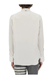 Thom Browne men’s crisp white long-sleeved button-up shirt with classic collar and subtle stitching details
