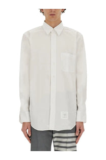 Thom Browne men’s white long-sleeved button down shirt with chest pocket and label at bottom hem
