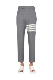 Thom Browne men’s classic gray tailored trousers with three bold white stripes on the lower leg in structured fabric