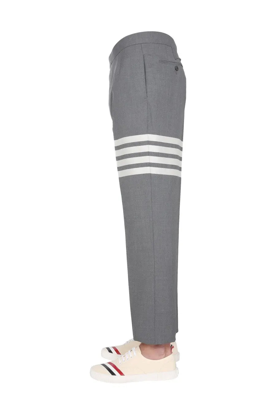 Thom Browne men’s classic gray wool trousers with three bold white stripes on lower leg and tailored fit