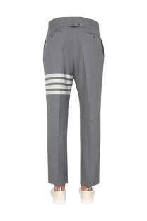 Thom Browne men’s classic gray wool trousers with three bold white stripes on the lower leg and buttoned waistband