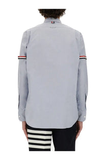 Thom Browne men’s classic light gray long-sleeve button-up shirt with red white and black striped cuffs